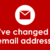 White envelope icon and text: We’ve changed our email address! on a red background.